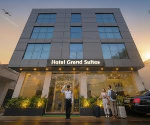 a police officer stands in front of a hotel at Hotel Grand Suites Premier - Near Delhi Aerocity in New Delhi