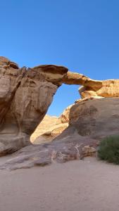 an arch in a rock formation in the desert at Maea wade ram in Disah +11 photos