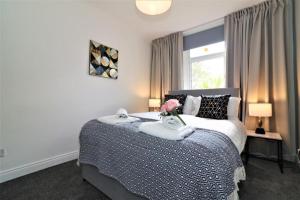 a bedroom with a bed with two towels on it at Macintosh lower in Bellshill