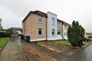 a house sitting on the side of a street at Macintosh lower in Bellshill