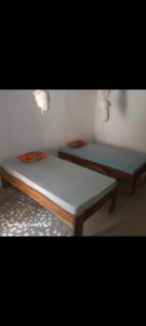 two beds sitting next to each other in a room at J'adore House in Abémé +7 photos