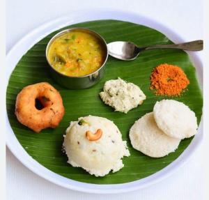 a plate of food on top of a banana leaf at CHIDAMBARAM Bala Residency in Chidambaram