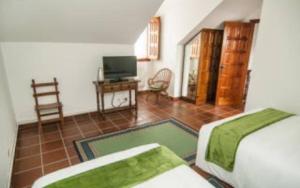 a bedroom with a bed and a flat screen tv at Casa rural La rectoral in Areas +11 photos