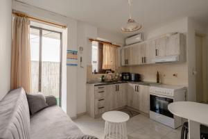 a kitchen with a couch and a table in a room at Blue Lemon Hideaway in Poros