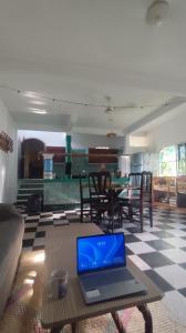 a laptop sitting on a table in a living room at Jungle Palace hostal santaella in Puerto Escondido