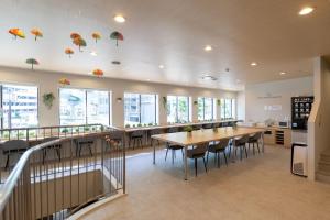 a restaurant with a table and chairs and umbrellas on the ceiling at Hotel Kiyoshi Nagoya in Nagoya