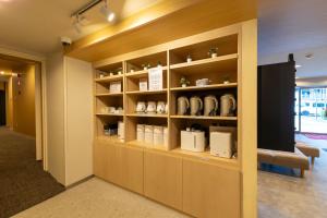 a room with a shelf with cups on it at Hotel Kiyoshi Nagoya in Nagoya +19 photos