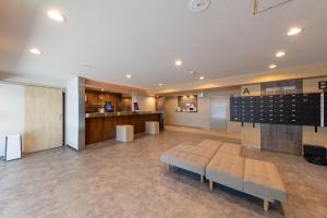 a waiting room with a bench in the middle of a building at Hotel Kiyoshi Nagoya in Nagoya