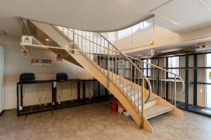 a staircase in a building with a glass railing at Hotel Kiyoshi Nagoya in Nagoya