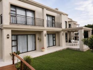 a large house with a lawn in front of it at On Appointment at the Sea in Wilderness
