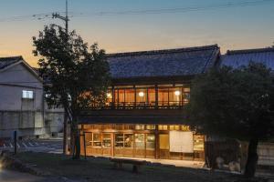 a building with glass doors and a bench in front of it at VILLA COMMUNICO,Nara in Nara