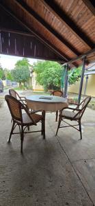 a table and two chairs sitting under an umbrella at Kuća za odmor BARSON in Vukovar