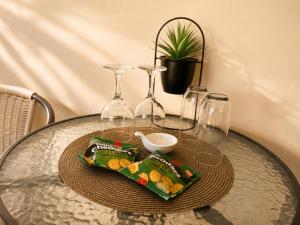 a table with wine glasses and a tray of snacks at On Appointment at the Sea in Wilderness