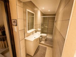 a small bathroom with a sink and a toilet at On Appointment at the Sea in Wilderness +11 photos