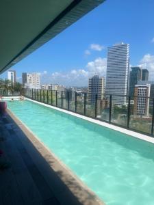 a swimming pool with a view of the city at FLAT Executivo próx Consulado Americano in Recife