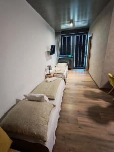 a row of beds in a room at Jáde Residence Apartman in Sárvár