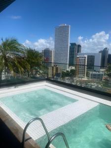 a swimming pool with a view of the city at FLAT Executivo próx Consulado Americano in Recife
