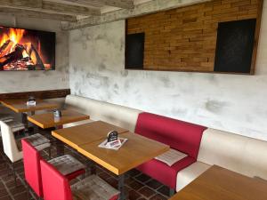 a restaurant with two tables and a fireplace at Penzion Černý Sklep in Dobšice