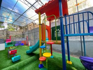 a playground with a slide and play equipment at Meteor Garden in Nairobi