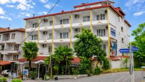 a large white building on the side of a street at Green Moringa Termal Hotel in Termal