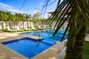 a swimming pool with lounge chairs next to a resort at Green Moringa Termal Hotel in Termal