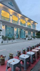 a building with tables in front of it at Luangaloun Guesthouse in Luang Prabang