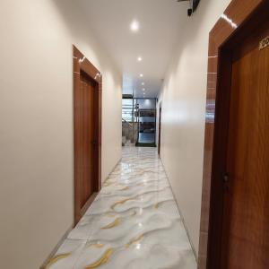 a hallway with a marble floor with a long corridor at Marina Executive Rooms in Navi Mumbai