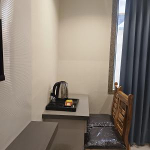 a room with a table with a tea kettle on it at Marina Executive Rooms in Navi Mumbai +24 photos