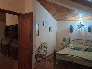 a bedroom with a bed and a chair in a room at AQC - A Quinta Chama in Caldas da Rainha +35 photos