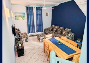 a living room with a table and a couch at Blue Haven in Grand-Baie