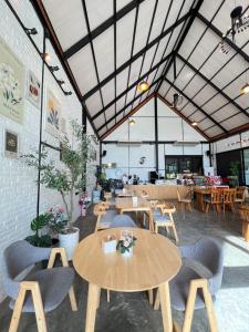 a restaurant with wooden tables and chairs and tables at ธนาภา 