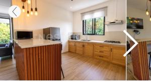 a kitchen with wooden cabinets and a counter top at Maranatha Villa in La Gaulette