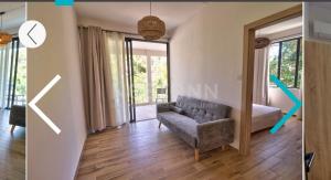 a living room with a couch and a window at Maranatha Villa in La Gaulette +5 photos