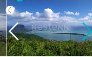 a view of the ocean with a mountain in the distance at Maranatha Villa in La Gaulette