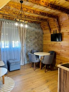 a dining room with a table and chairs at Ðedovina mountain cabins in Žabljak +30 photos