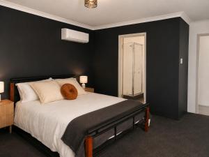 a bedroom with a bed with a stuffed animal on it at Layover Lounge in Perth