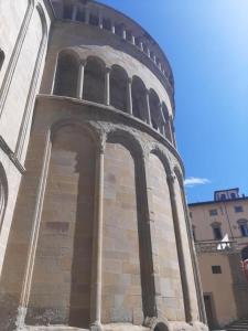 a tower of a building with arches on it at Attico le due Torri in Arezzo