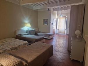 a bedroom with two beds and a living room at Attico le due Torri in Arezzo