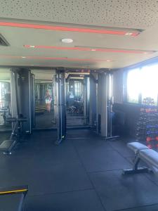 a gym with a woman walking through the doorway at FLAT Executivo próx Consulado Americano in Recife