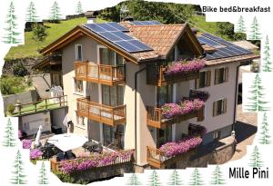 a house with solar panels on its roof at Bike Bed&Breakfast Mille Pini in Baselga di Pinè