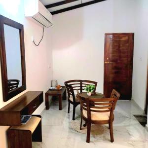 a living room with a table and chairs and a mirror at Beach 365 in Nilaveli +6 photos
