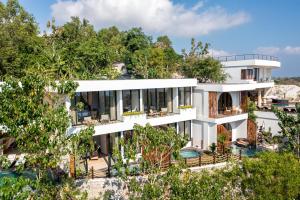 an aerial view of a building with trees at Villa Karilla in Toyapakeh