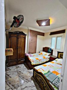 a bedroom with two beds and a dresser at لؤلؤة البحر in Alexandria
