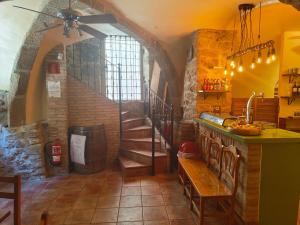 a kitchen with a staircase and a room with a table at La Bodega Del Camino in Lorca