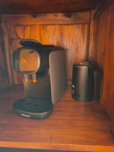 a coffee maker sitting on a wooden table at La Bodega Del Camino in Lorca