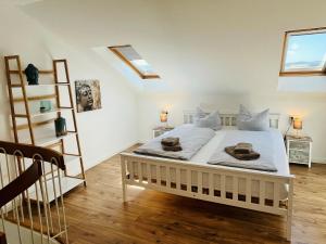 a bedroom with a white bed with towels on it at See Apart 7 in Öhningen