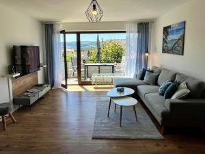 a living room with a couch and a table at See Apart 7 in Öhningen
