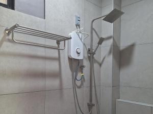 a shower in a bathroom with a shower head at Basilia Guest House in Bantayan Island