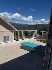 a blue bench sitting on top of a balcony at Casa de Ferias no Gerês in Ferral