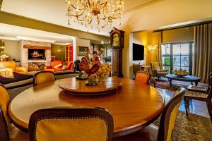 a dining room and living room with a large wooden table at Batavia Boutique Hotel in Stellenbosch